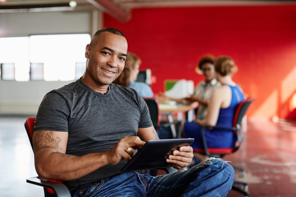 Confident male designer working on a digital tablet