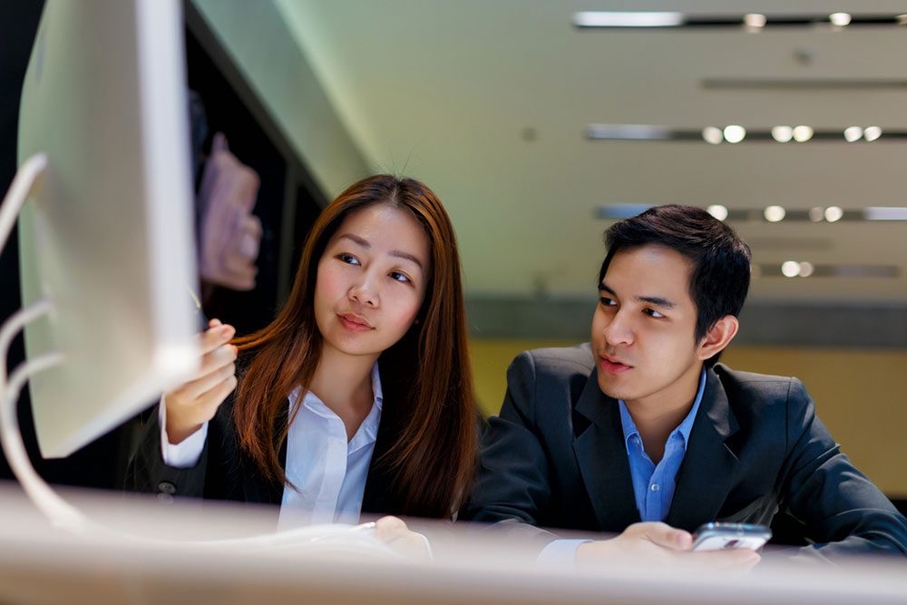 two people working on computer