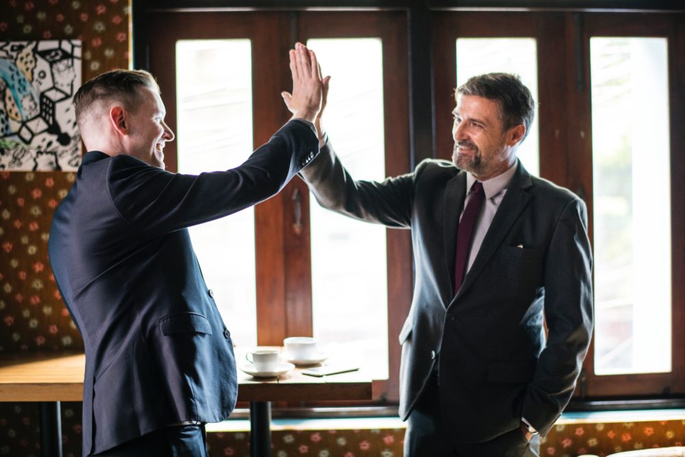 men giving each other a high five