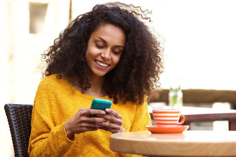 woman texting while sitting