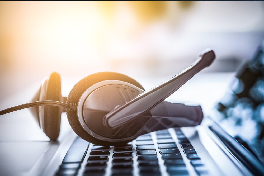 phone headset sitting on laptop keyboard