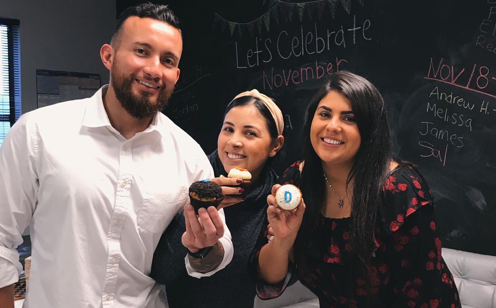 broadvoice team members holding cupcakes