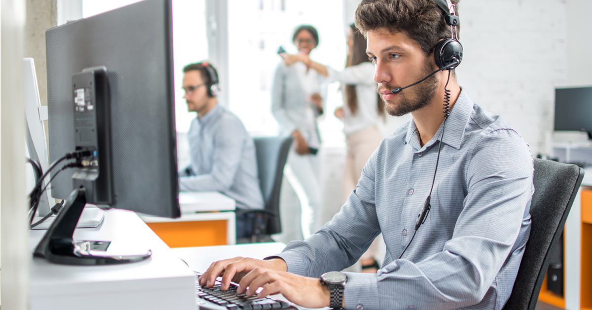 man on computer typing at work