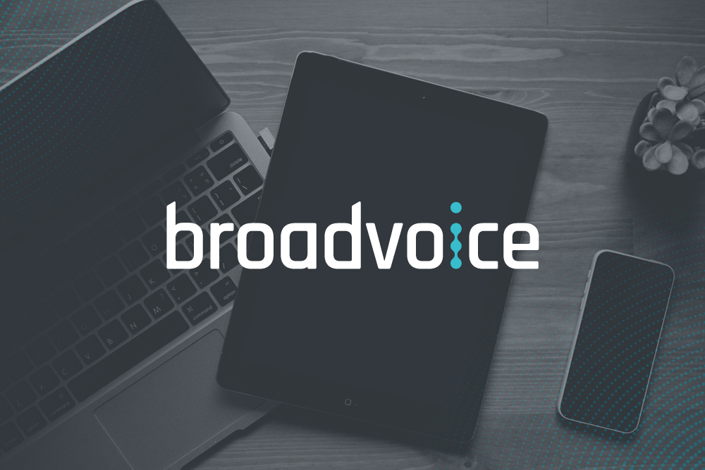 broadvoice logo over desk with computer on it