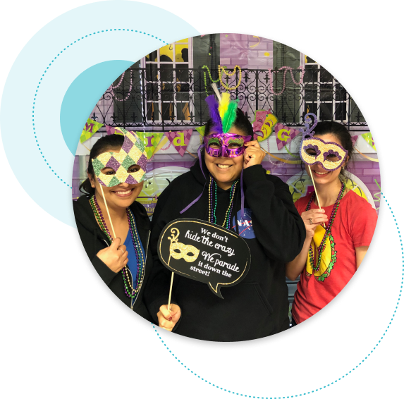 team members with mardi gra mask on